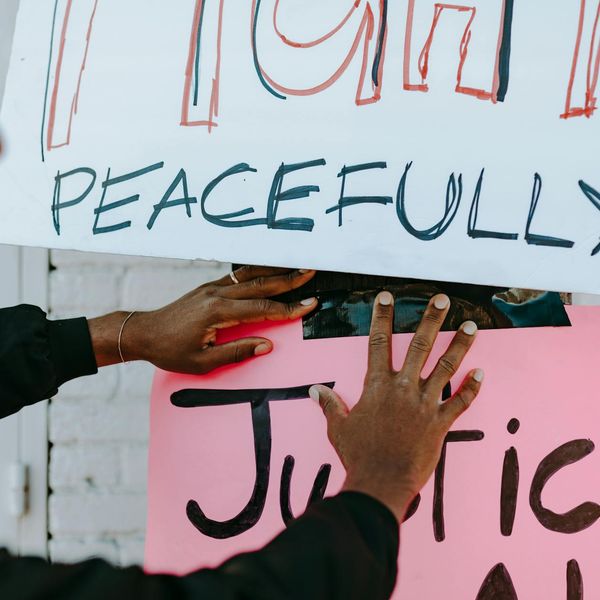 Person peacefully meditating in a bright, sunlit room.