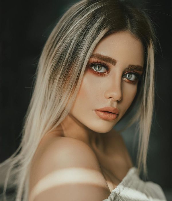 Woman with a calm and focused expression, looking into the distance.